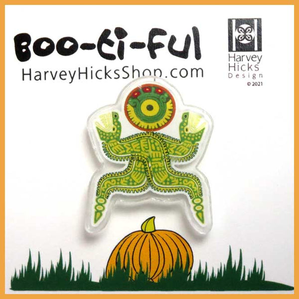 Halloween pin featuring an illustration of a  lizard crawling over the moon