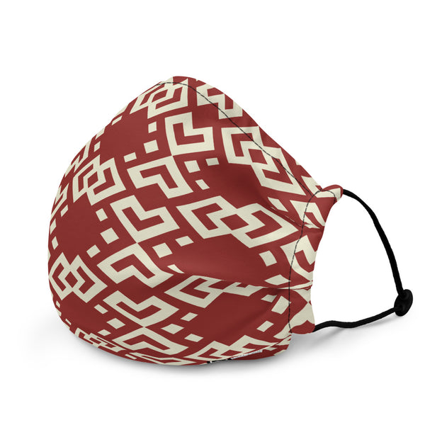 Face mask featuring a variation of a Boshongo textile motif, wine